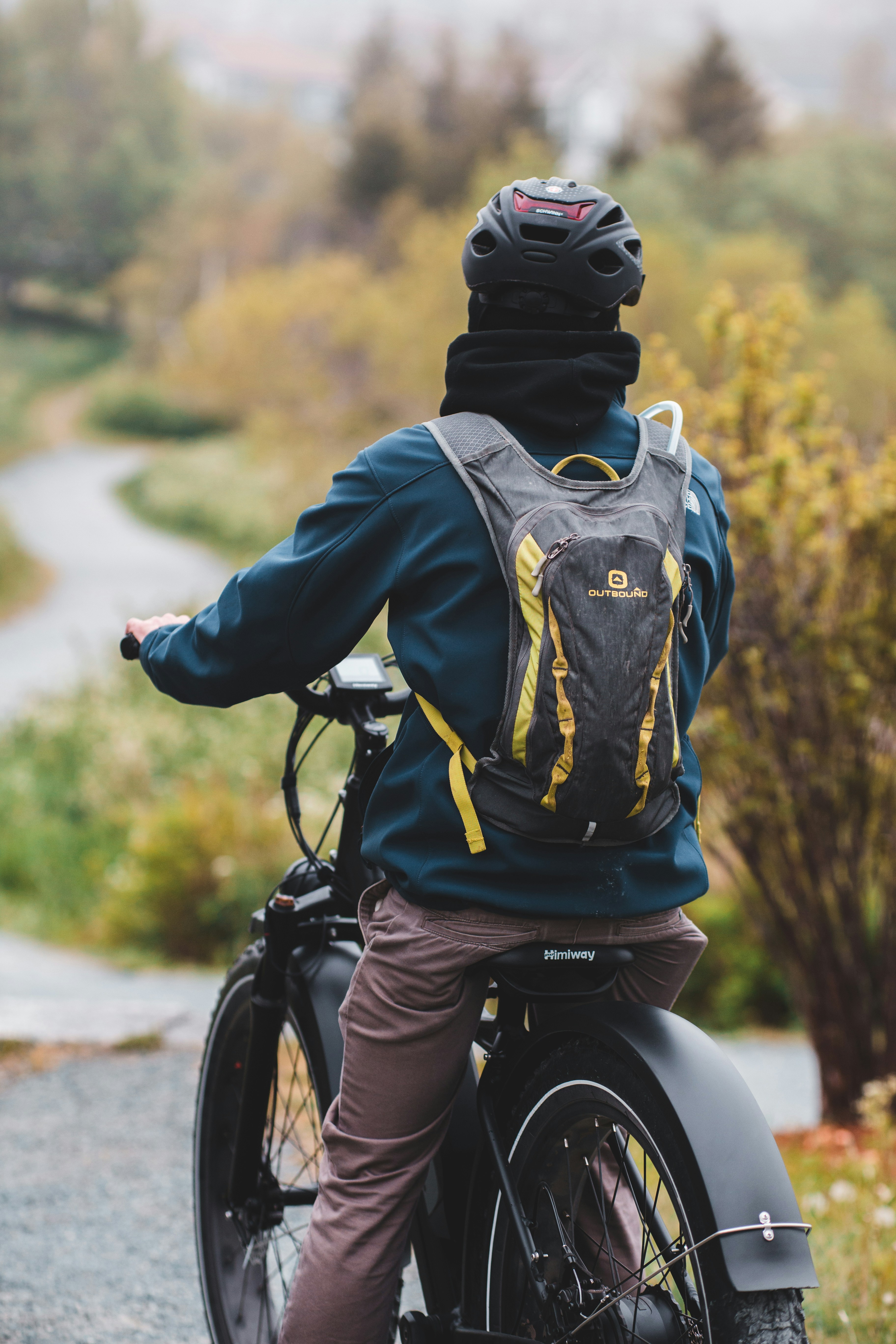 a person riding a bike with a backpack on the back