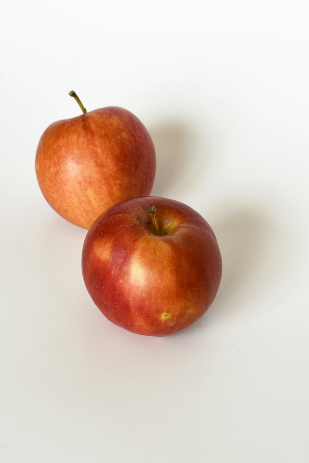 red apple on white table