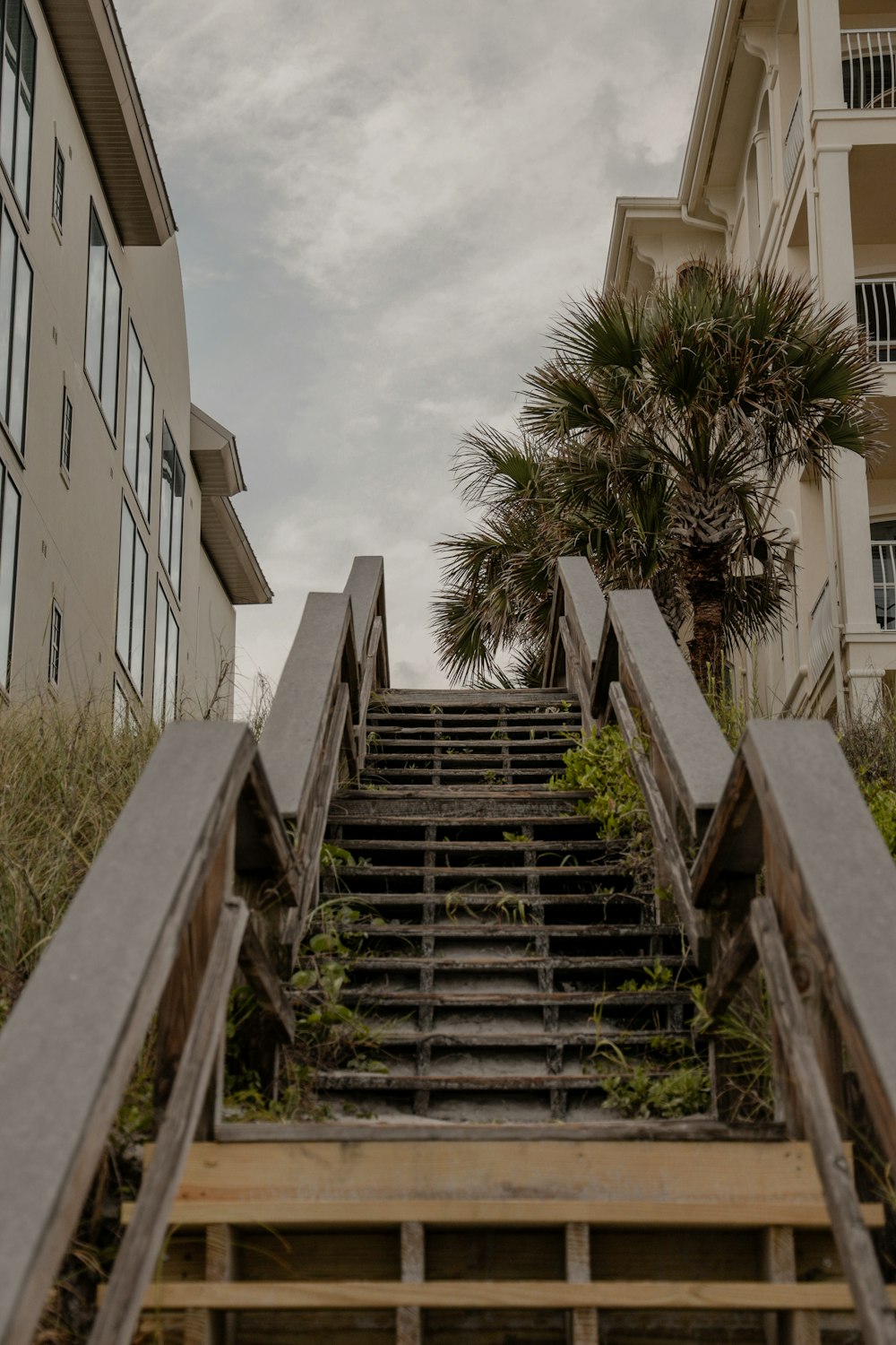gray concrete stairs near white concrete building during daytime