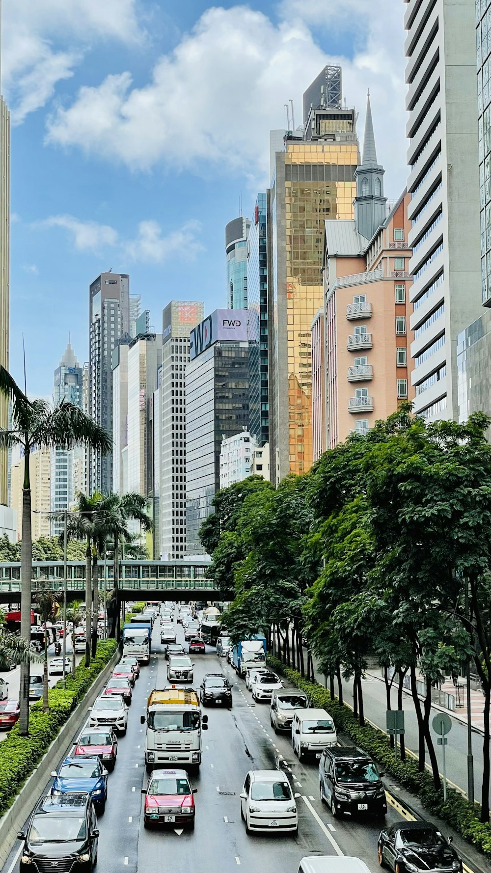 cars parked on parking lot near high rise buildings during daytime