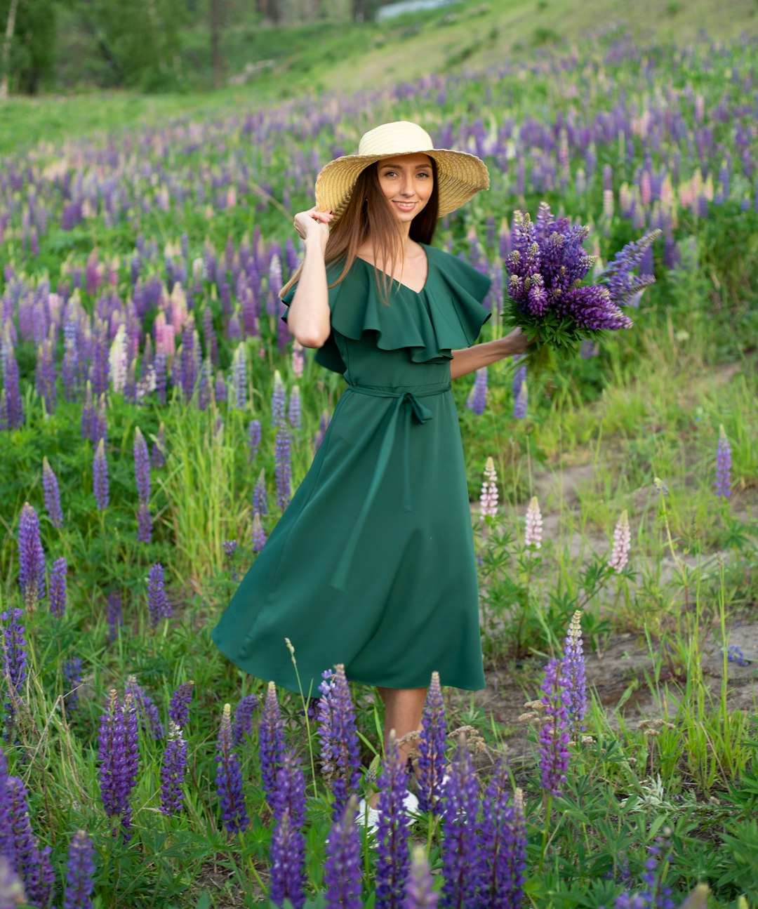 woman in blue dress standing on purple flower field during daytime