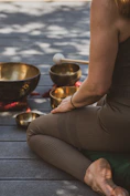A serene room softly lit with candles, featuring crystal singing bowls arranged for a sound bath session.