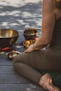 A serene room softly lit with candles, featuring crystal singing bowls arranged for a sound bath session.