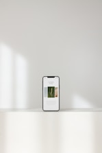 silver iphone 6 on white table