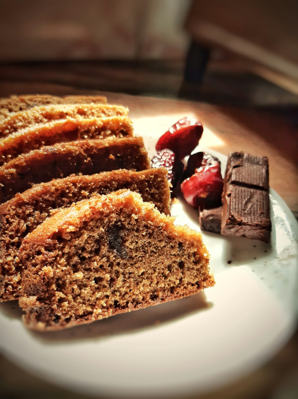 brown bread with strawberry jam on white ceramic plate