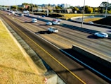 Aerial view of a highway with various commercial vehicles in motion.