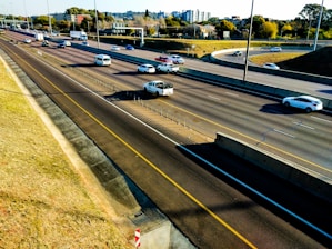 Aerial view of a busy highway with vehicles in motion during the day.