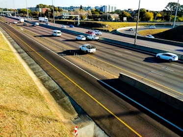 Aerial view of a busy highway with vehicles in motion during the day.