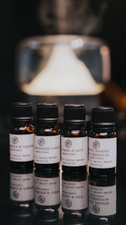 black glass bottles on white table