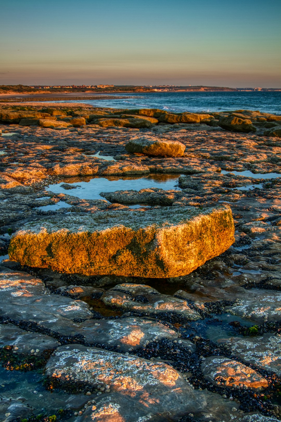 brown and gray rock formation on body of water during daytime