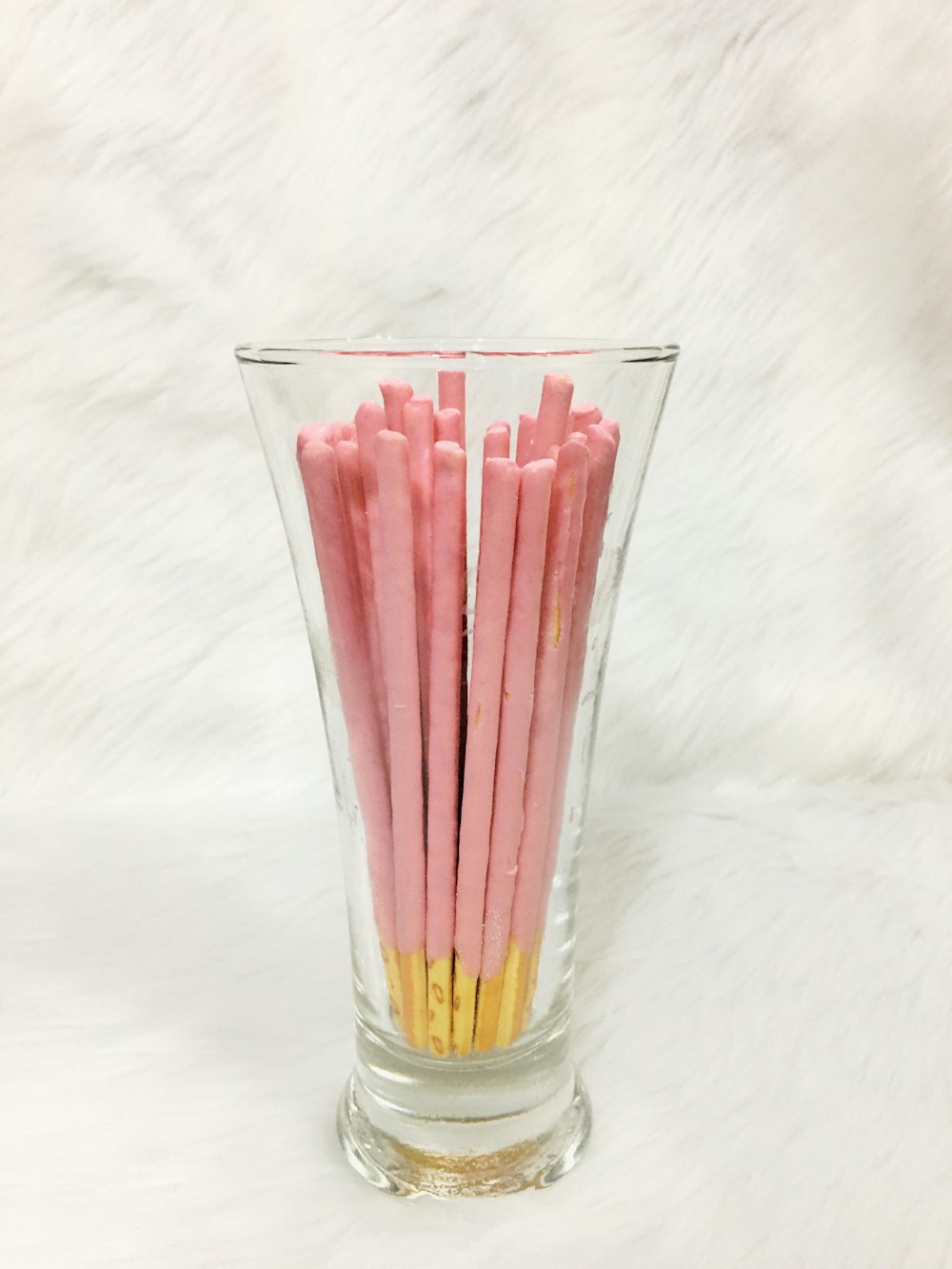 clear drinking glass with red straw
