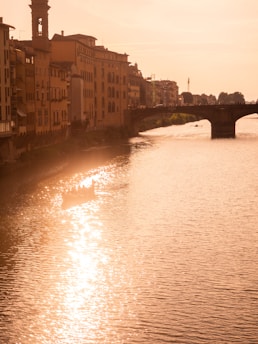 river between brown concrete buildings during daytime