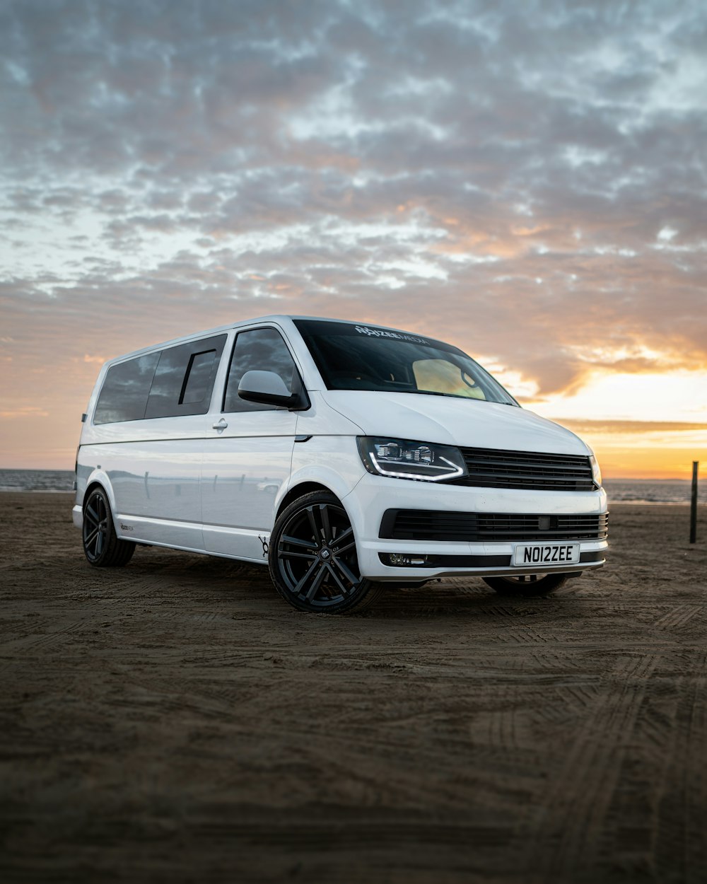 white mercedes benz c class on brown sand during sunset