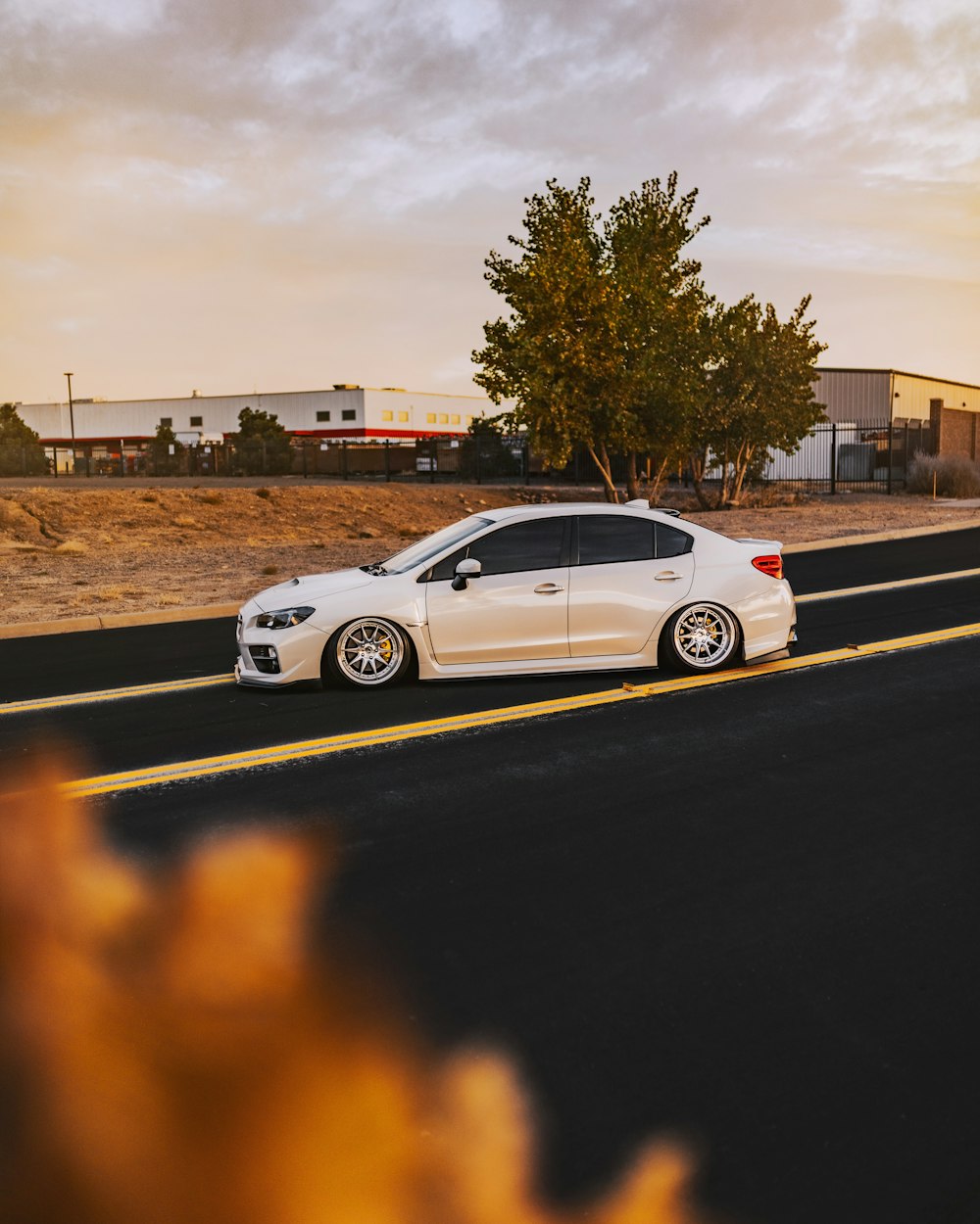 white coupe on road during sunset