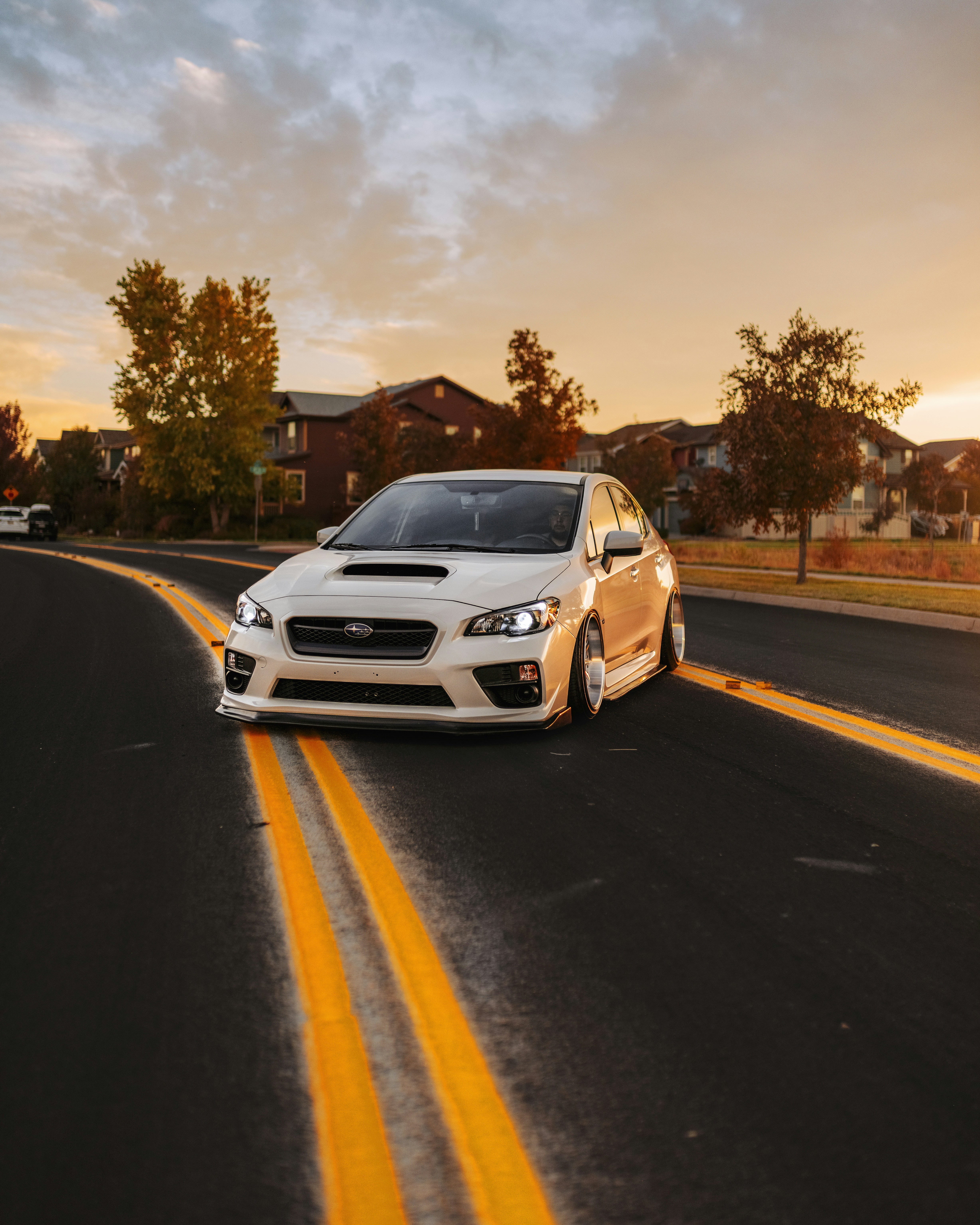 white car on road during sunset