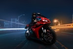 red and black sports bike on road during nighttime