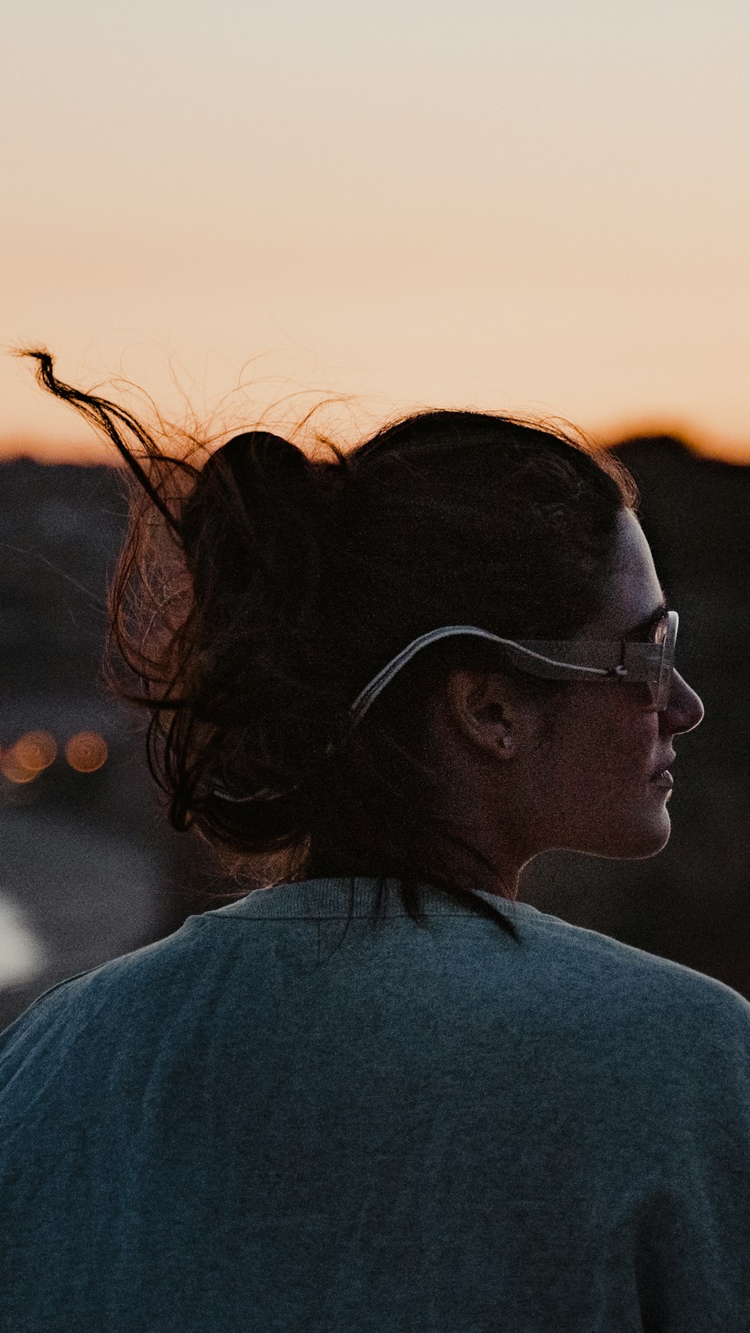 woman in gray shirt wearing black framed eyeglasses