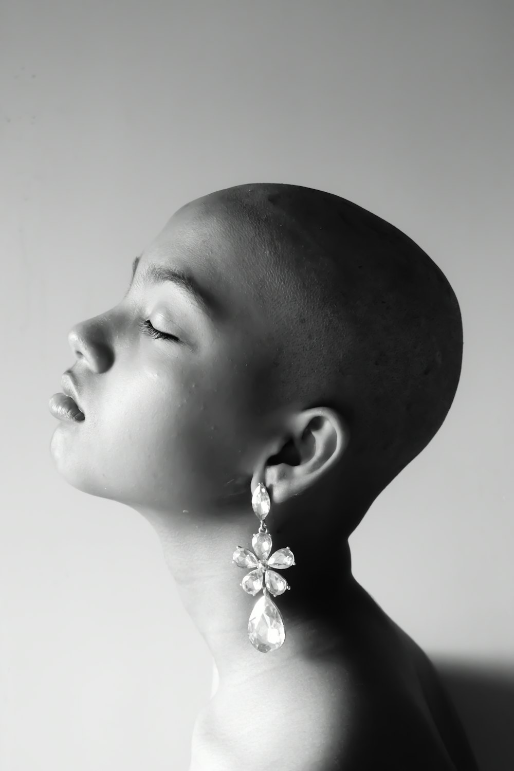 grayscale photo of woman wearing silver necklace