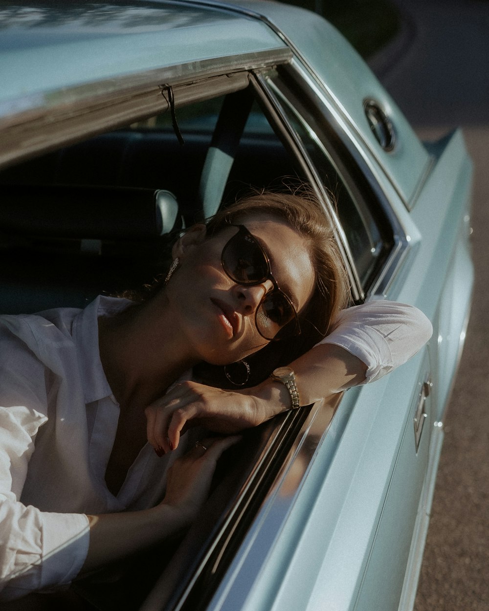 woman in white shirt wearing black sunglasses