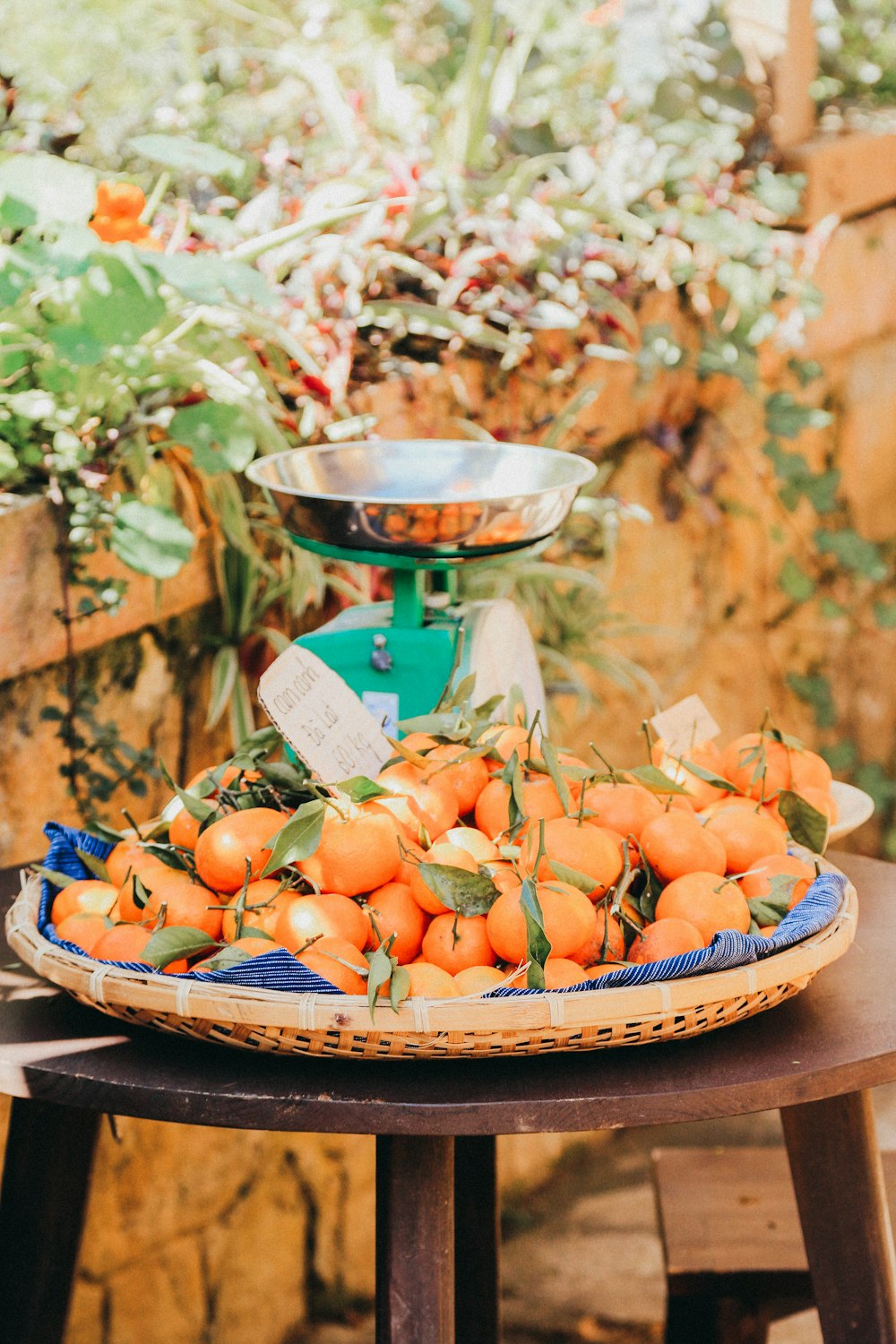 orange fruits on brown wooden bowl
