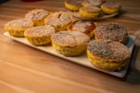 An overhead shot of a rustic wooden table filled with assorted baked goods.