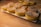 A rustic wooden table displaying an assortment of Finnish pastries with a blue and white cloth.