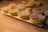 Close-up of assorted fresh bakery goods on a wooden table.