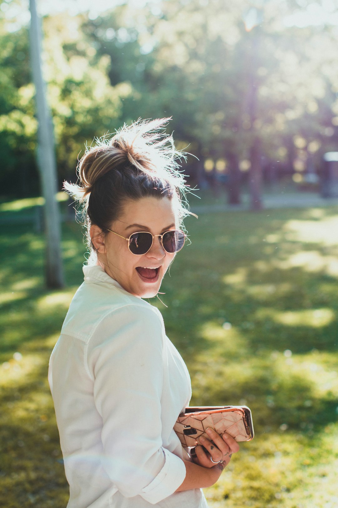 woman in white long sleeve shirt wearing black sunglasses