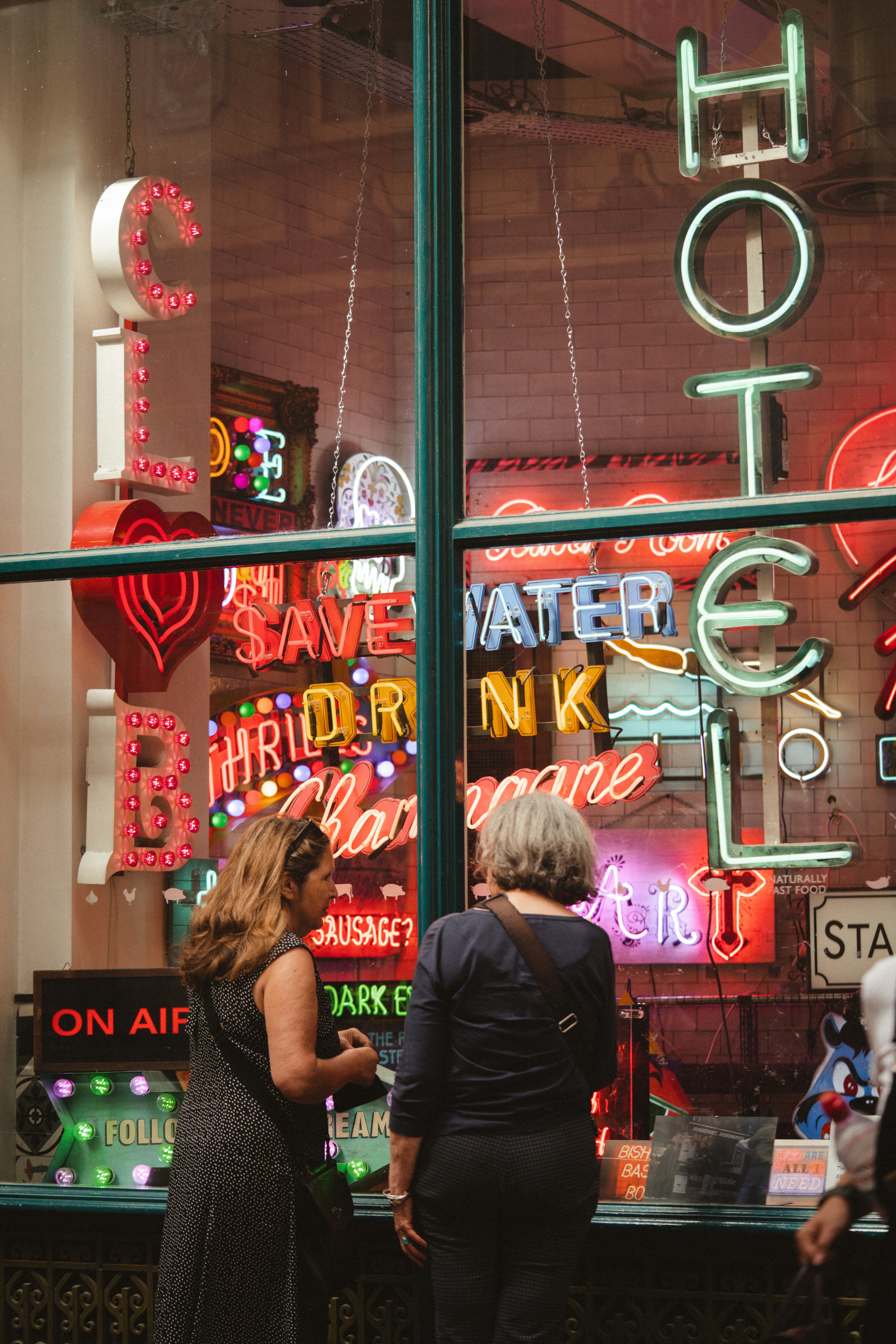 woman in black sleeveless shirt standing beside store
