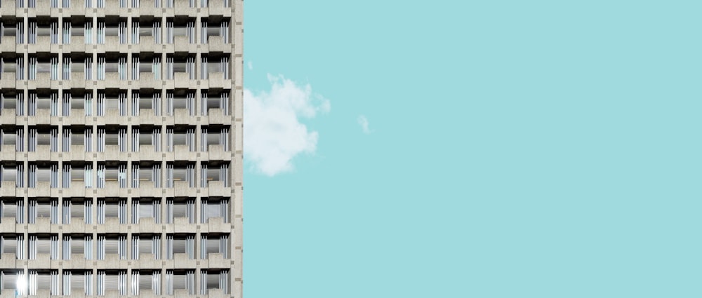 a tall building with windows and a sky background