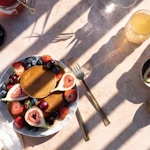 sliced strawberries and blueberries on white ceramic bowl