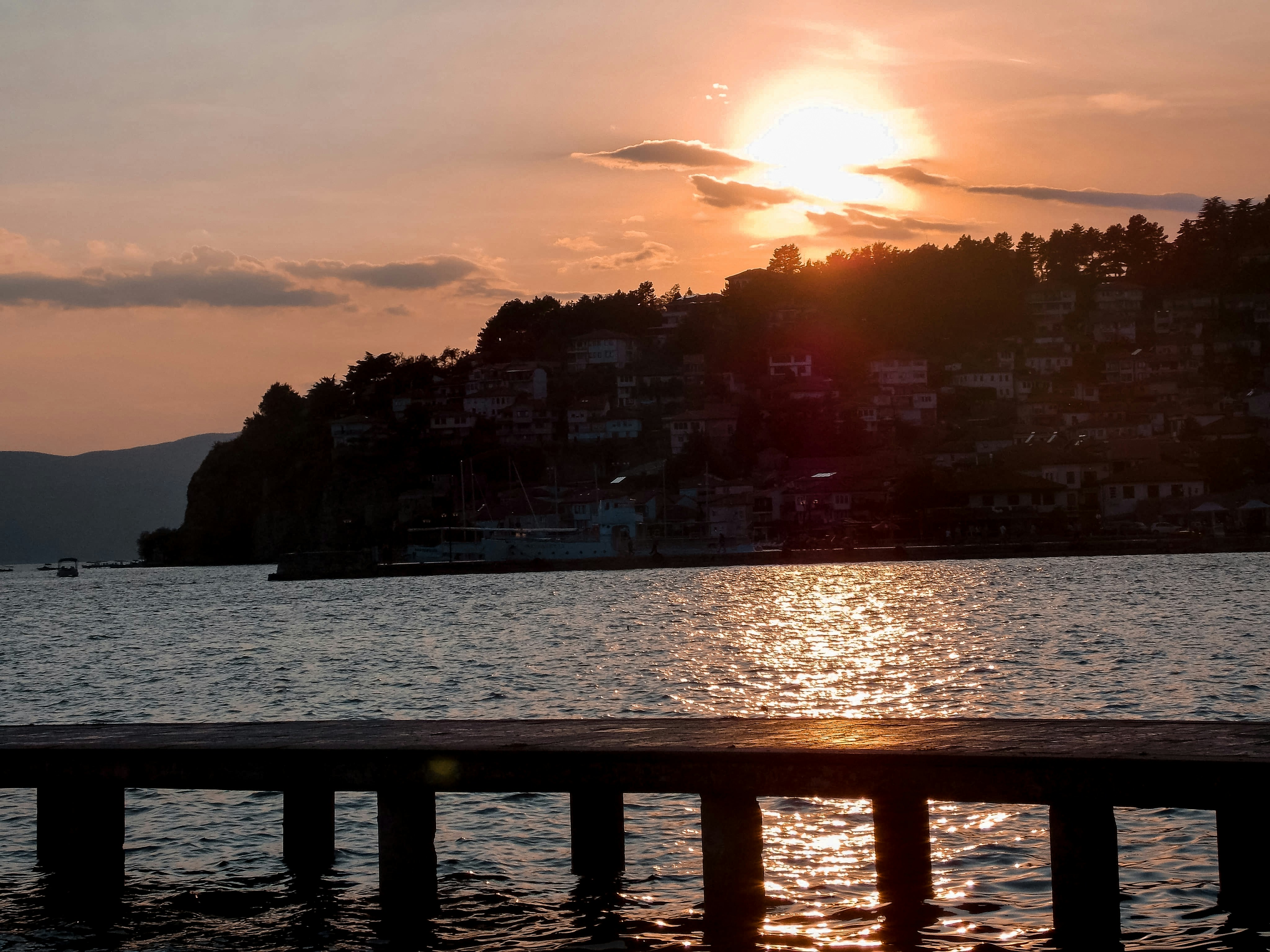 city buildings near body of water during sunset, 