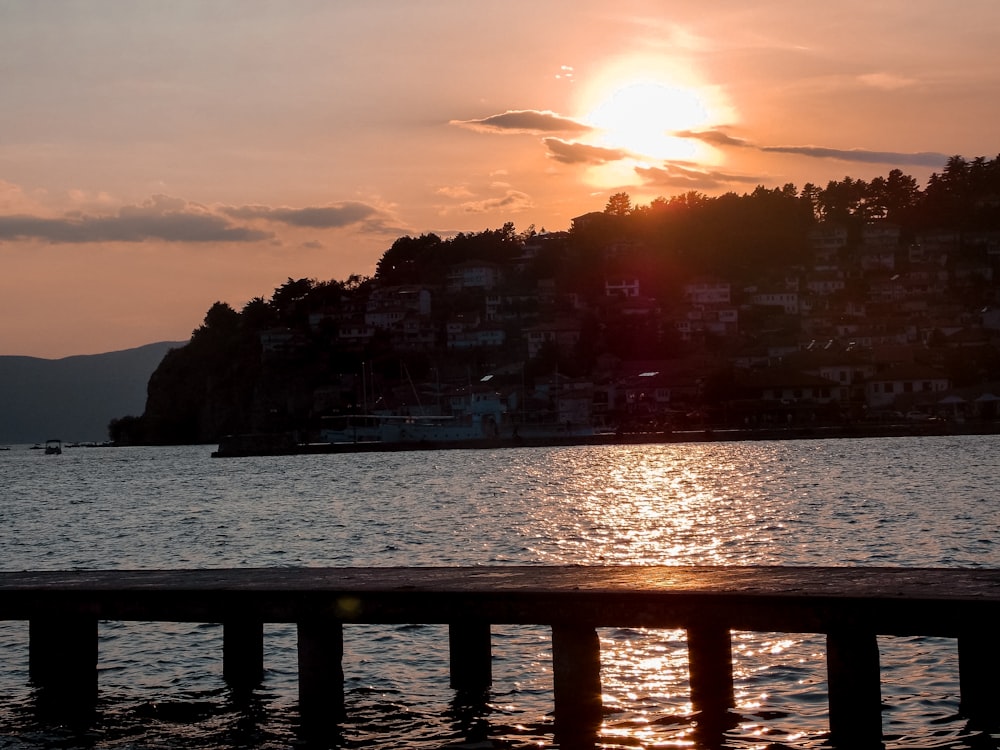 city buildings near body of water during sunset