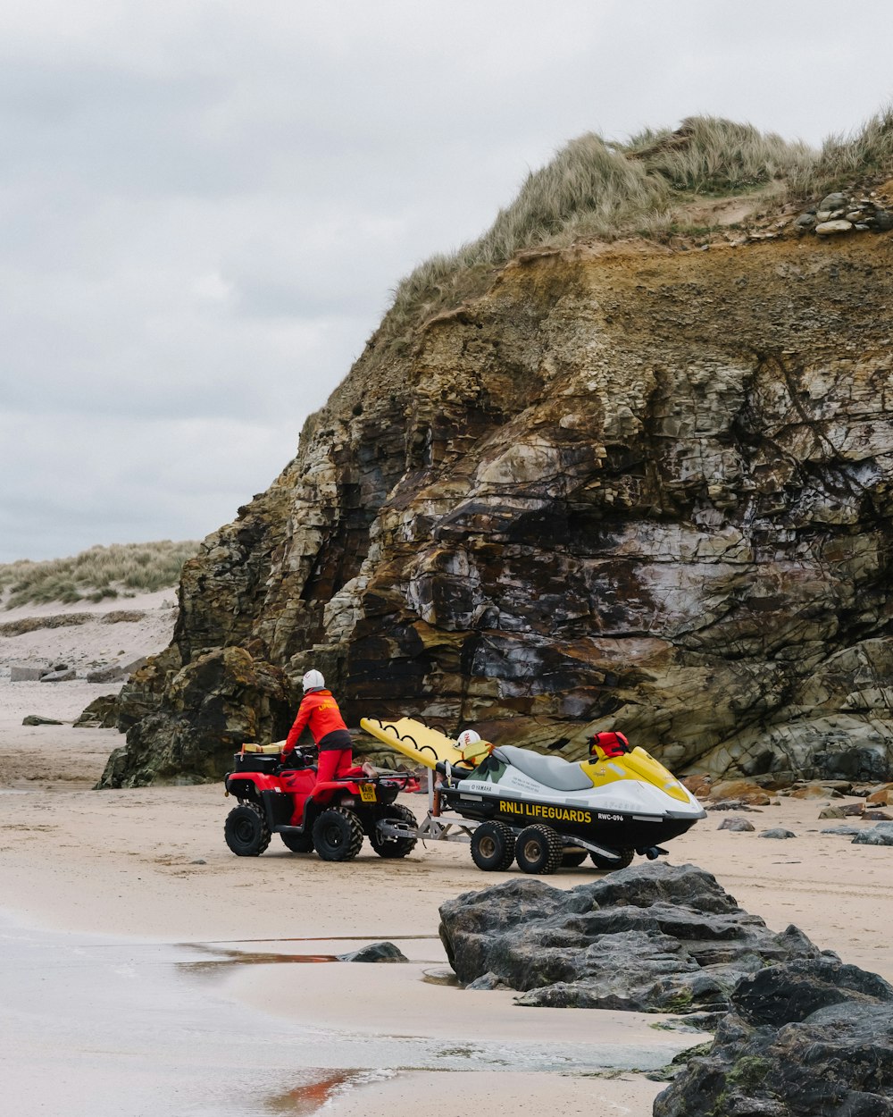 a person riding a four wheeler on a beach