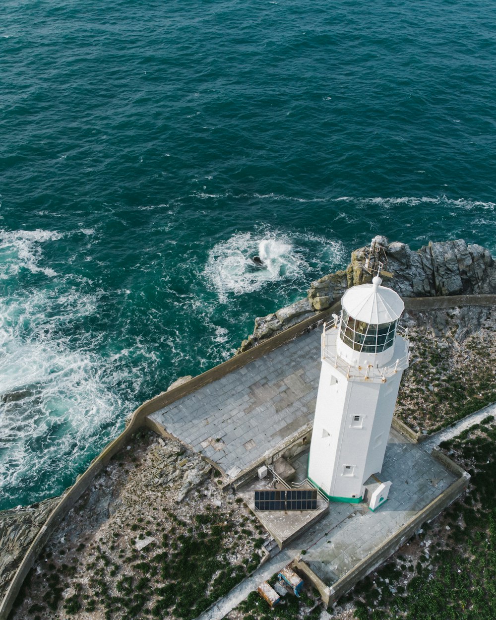 white concrete building near sea during daytime