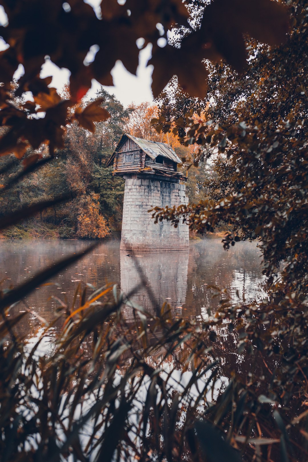 white and brown house near body of water during daytime