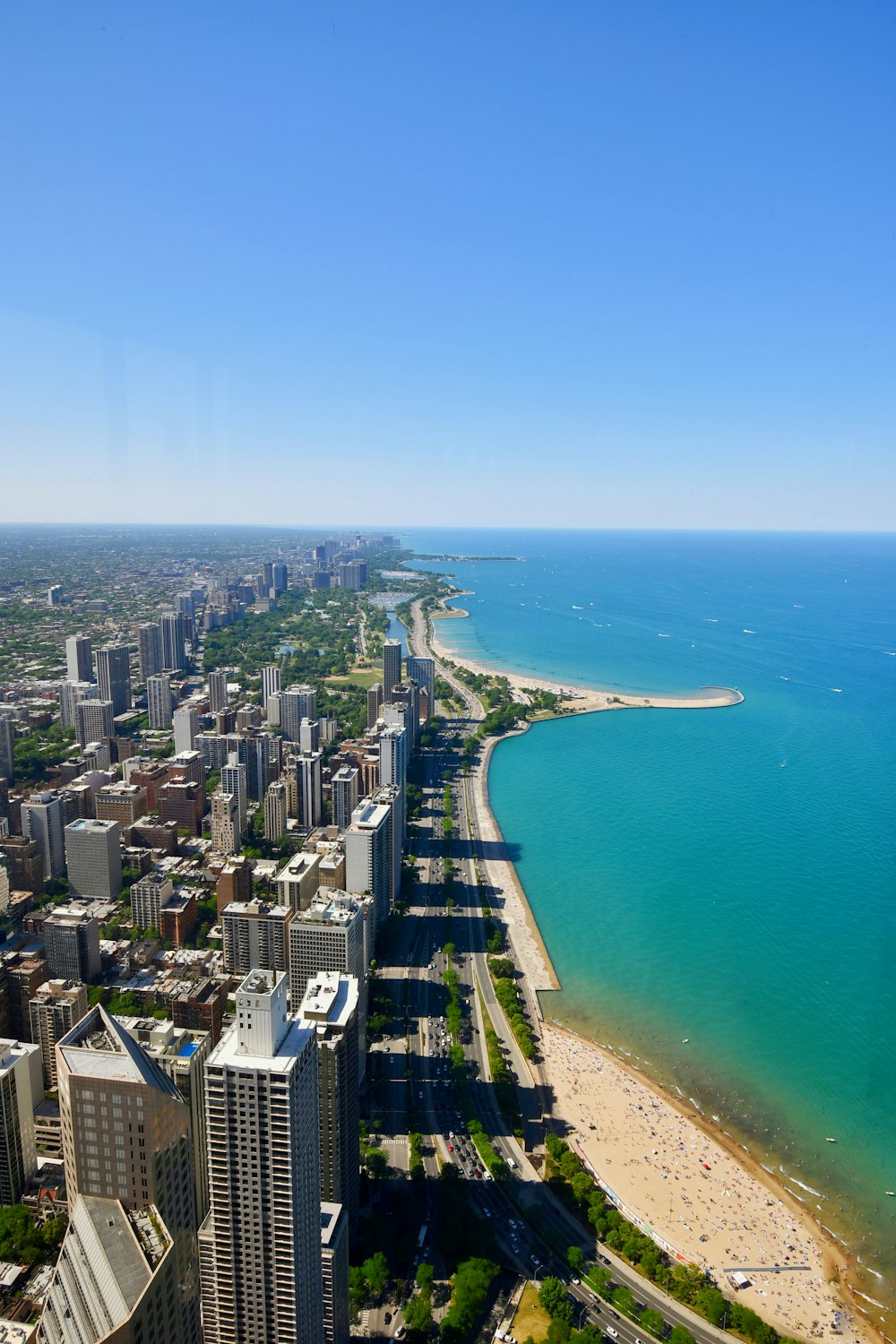 aerial view of city buildings near body of water during daytime