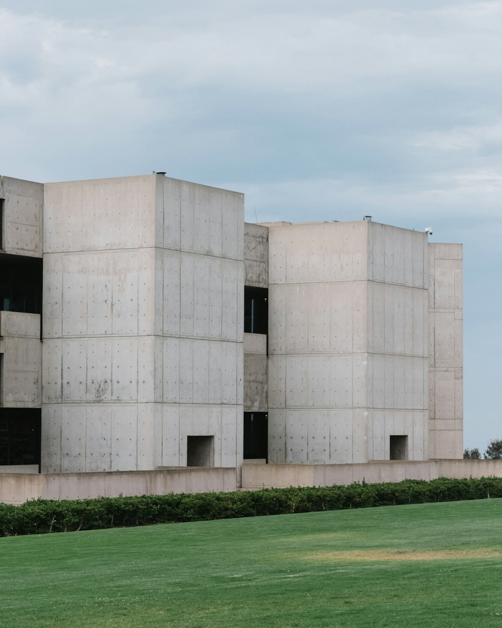 brown concrete building on green grass field during daytime