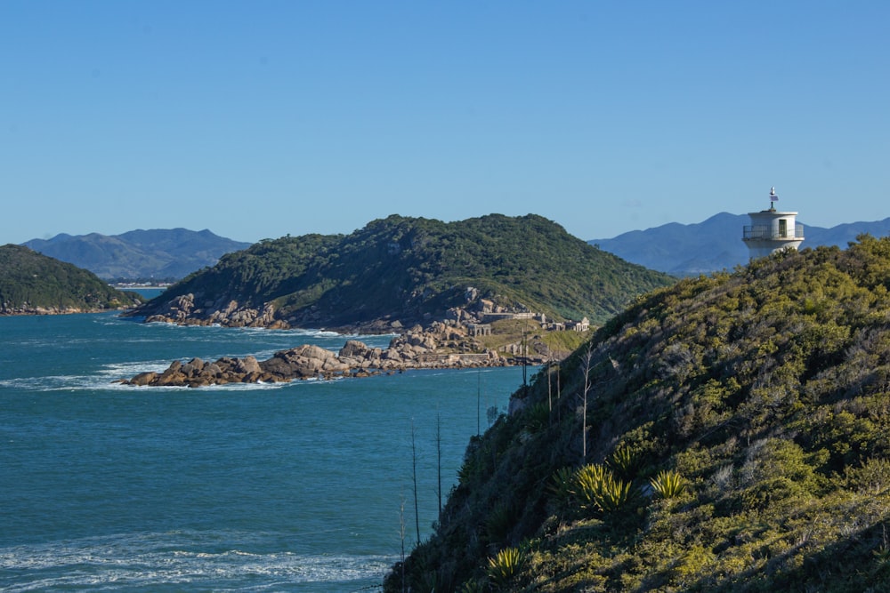 green mountain near body of water during daytime