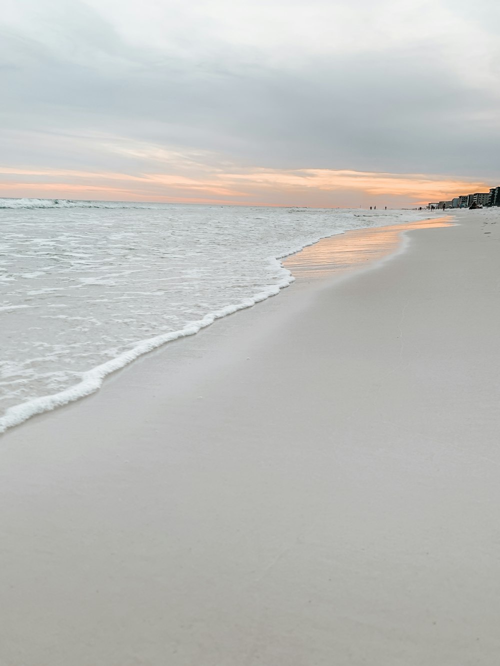 ocean waves crashing on shore during sunset