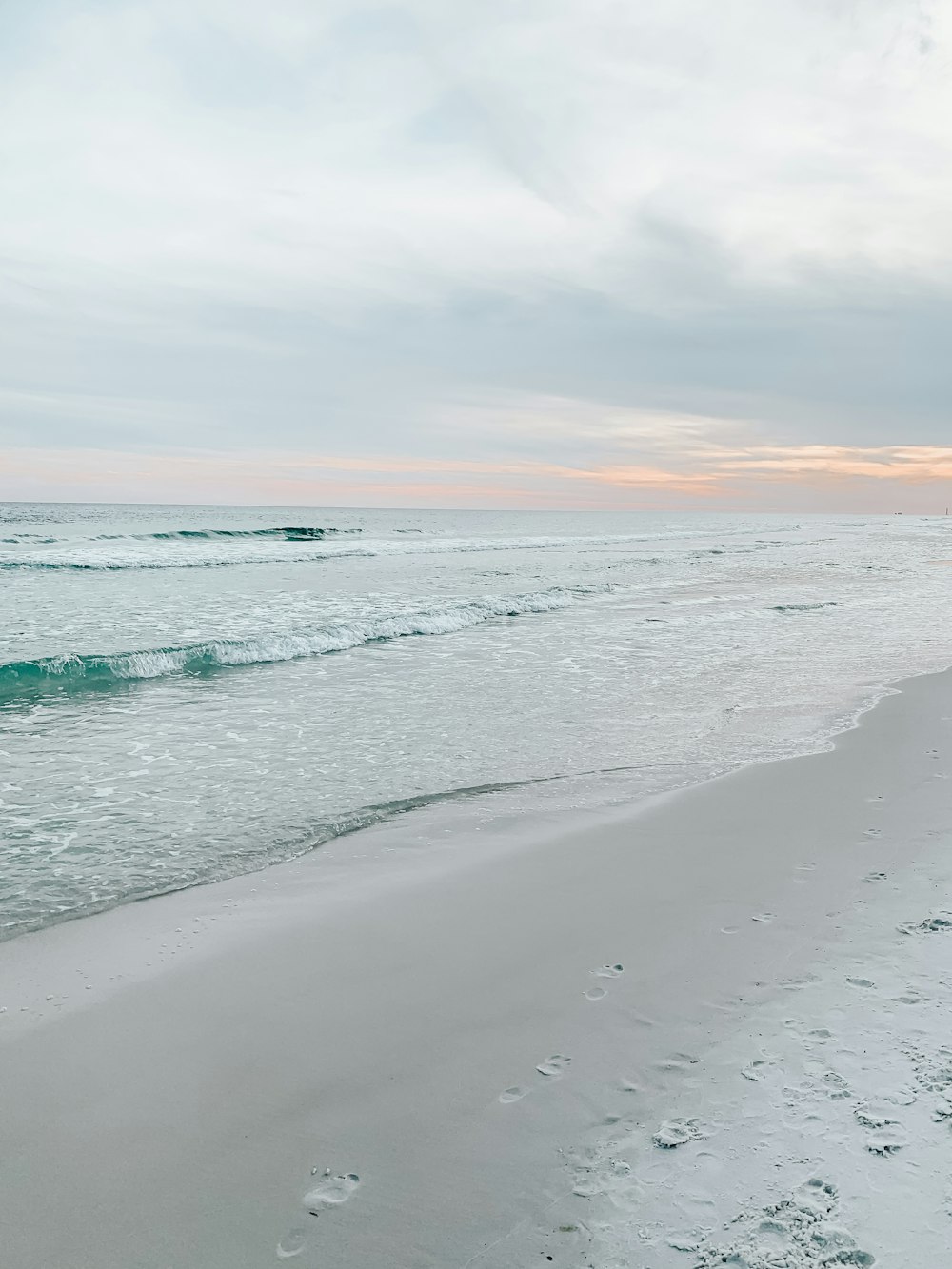 body of water under cloudy sky during daytime