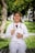 smiling woman in white long sleeve shirt with stethoscope on her neck