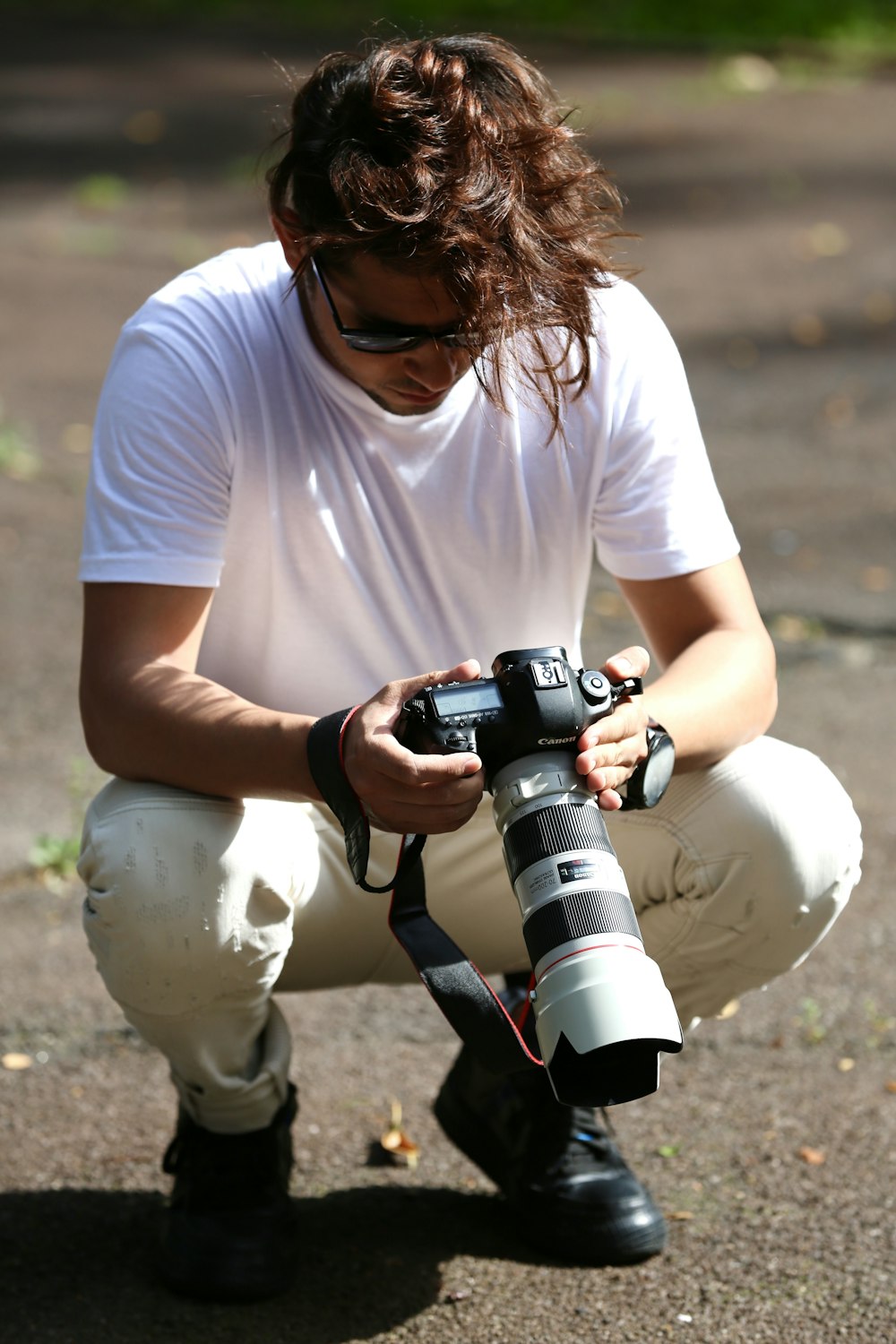 woman in white crew neck t-shirt holding black dslr camera