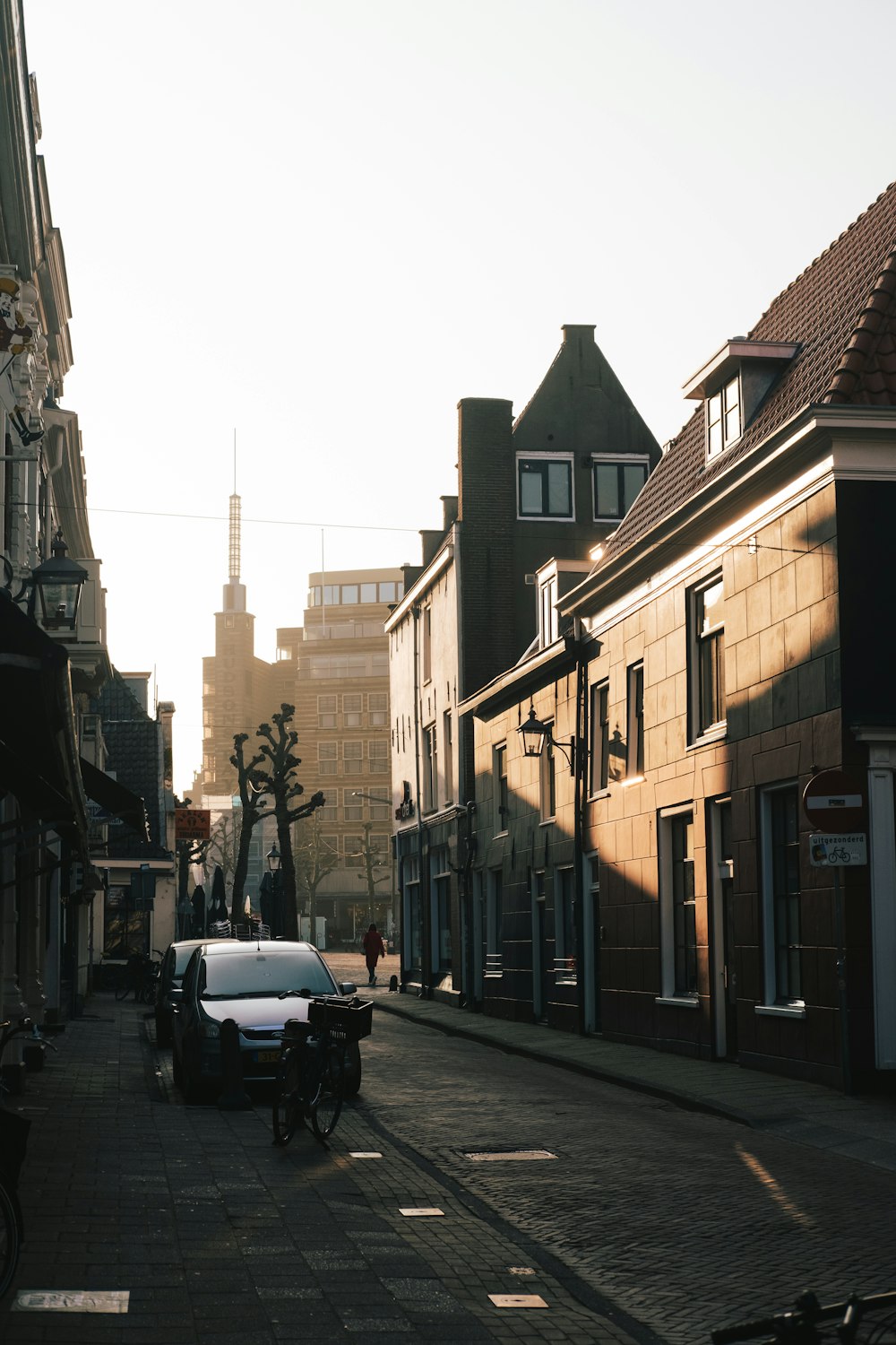 cars parked beside the road near buildings during daytime