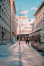 people walking on sidewalk near building during daytime