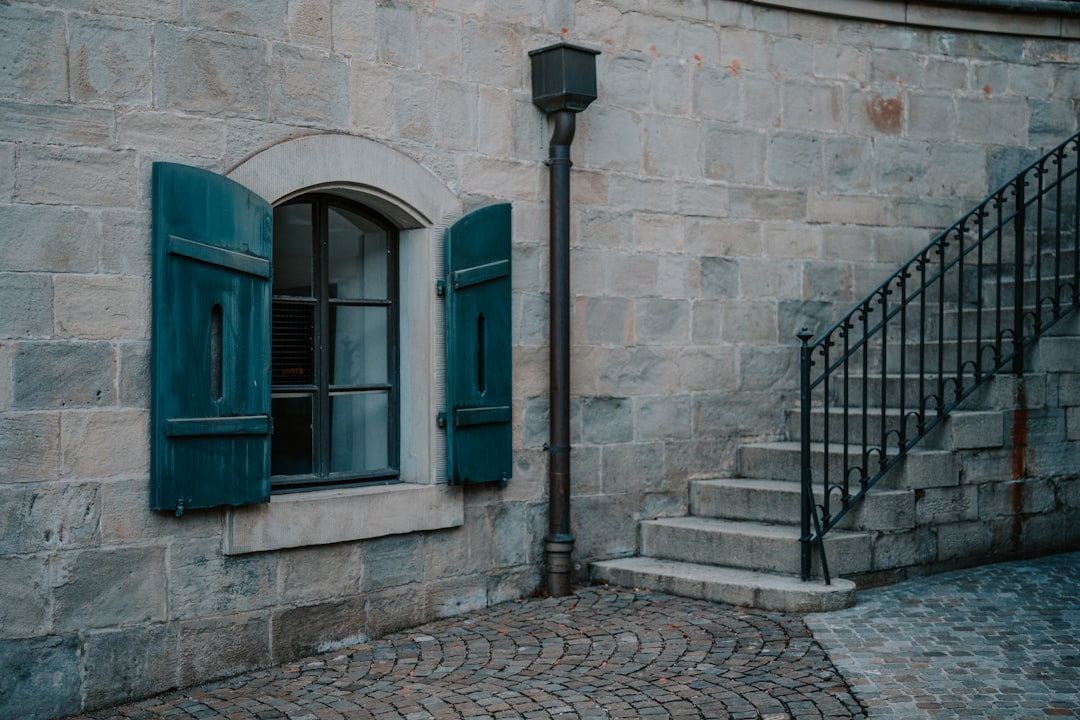 blue wooden door on brown brick wall