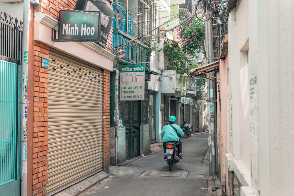 man in black jacket riding motorcycle on road during daytime