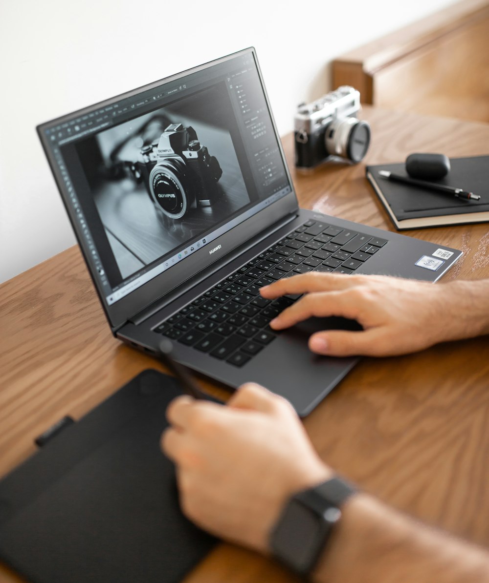 person using black laptop computer