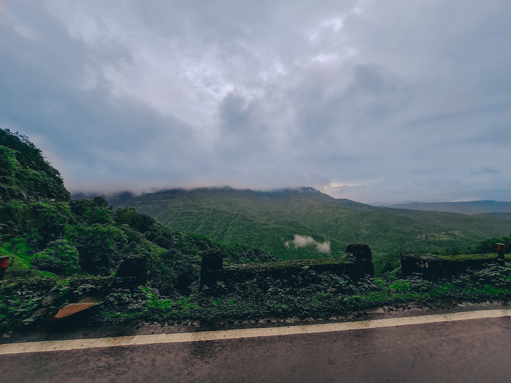 green mountain under white clouds during daytime