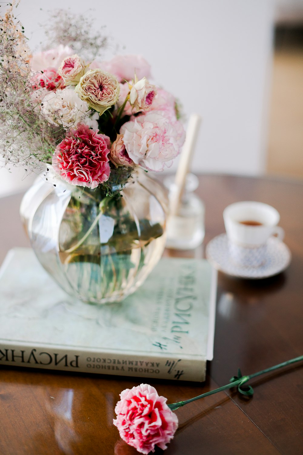 pink and white flowers in clear glass vase